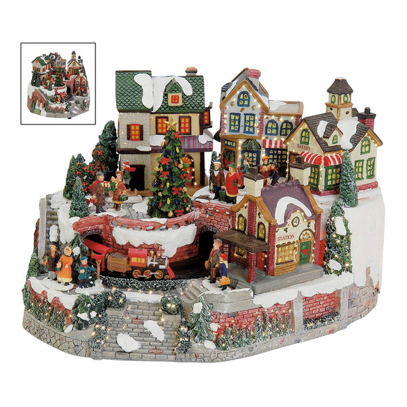 Village de Noël illuminé avec un train animé