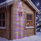 Père Noël sur une échelle lumineuse